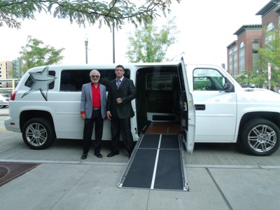Two men in front of Accessible Limousine Car